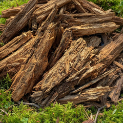 A pile of dry, rotting wooden logs exposed to air, likely to be used as habitat material for pets such as isopods and small reptiles.